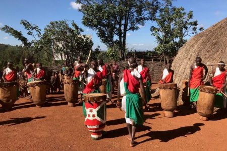 Villagers drumming and dancing